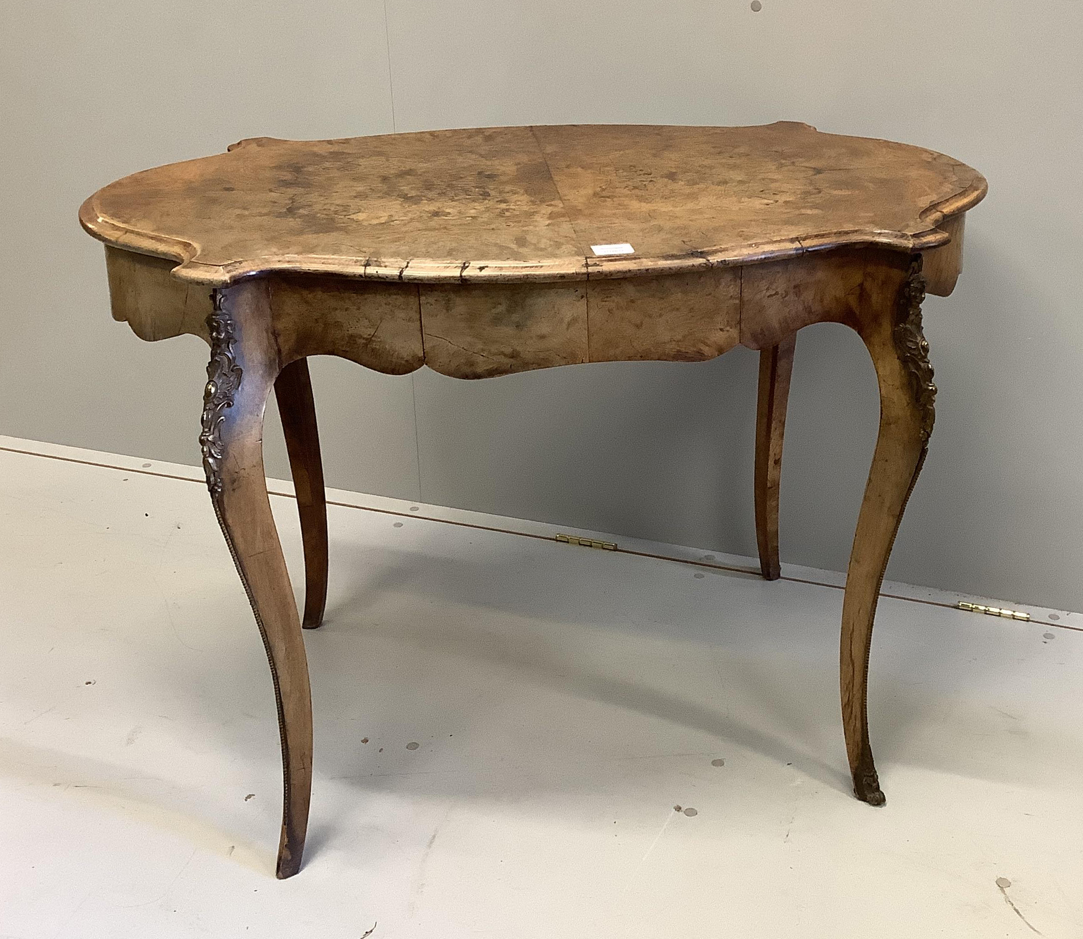 A Victorian gilt metal mounted oval walnut centre table, width 106cm, depth 66cm, height 74cm